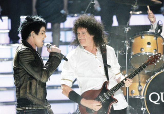 Adam Lambert (left) and Brian May, of Queen, perform during the season finale of