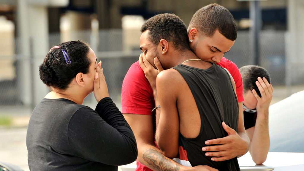 Friends and family members embrace outside the Orlando Police Headquarters during the investigation of a shooting at the Pulse night club, where as many as 20 people have been injured after a gunman opened fire, in Orlando, Florida, U.S June 12, 2016. REUTERS/Steve Nesius TPX IMAGES OF THE DAY