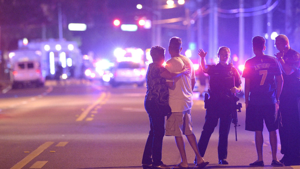 Orlando Police officers direct family members away from a multiple shooting at a nightclub in Orlando, Fla., Sunday, June 12, 2016. A gunman opened fire at a nightclub in central Florida, and multiple people have been wounded, police said Sunday. (AP Photo/Phelan M. Ebenhack)